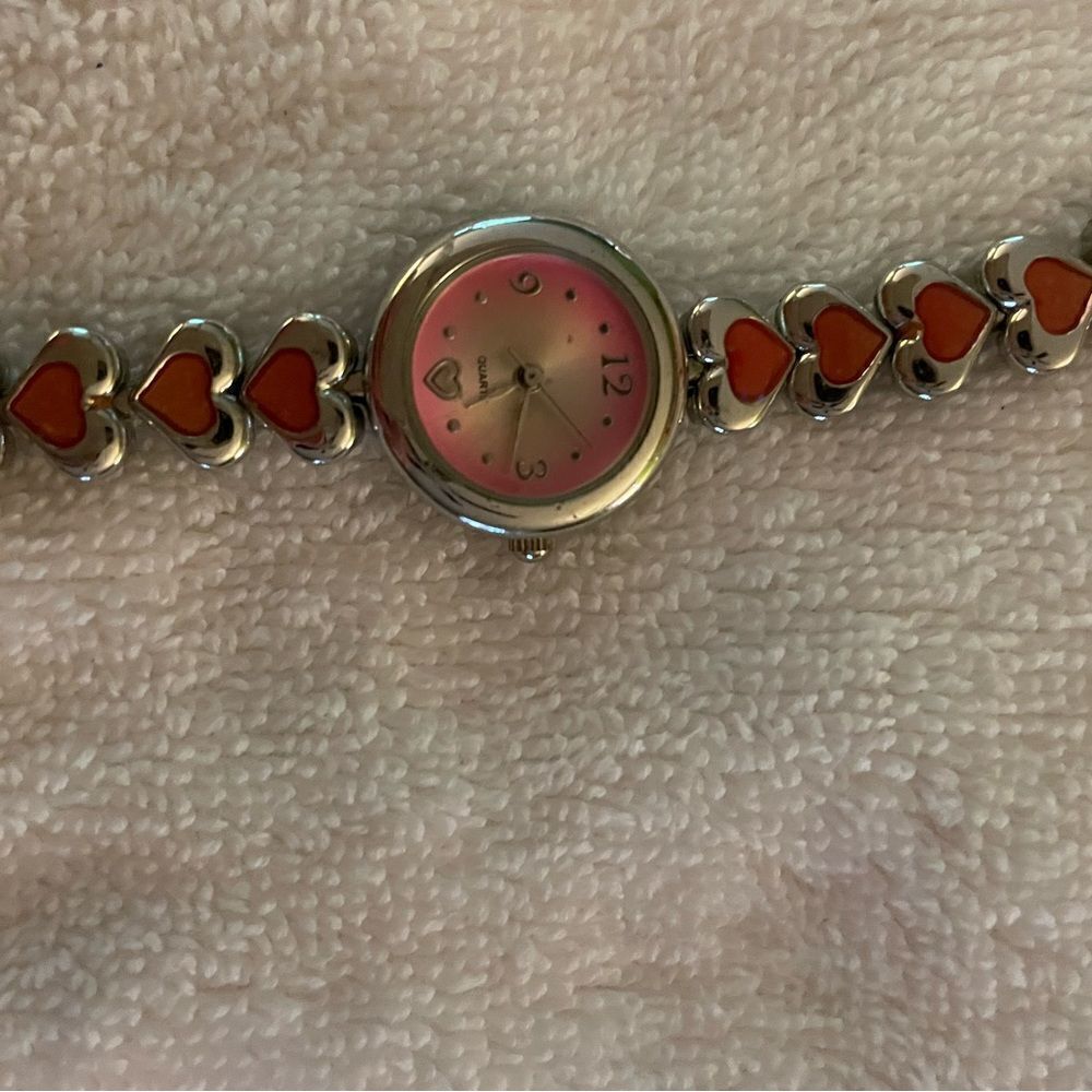 Pretty silver heart watch with pink. Quartz movement.